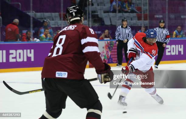 Martin Erat of Czech Republic shoots and scores against Sandis Ozolins of Latvia in the first period during the Men's Ice Hockey Preliminary Round...