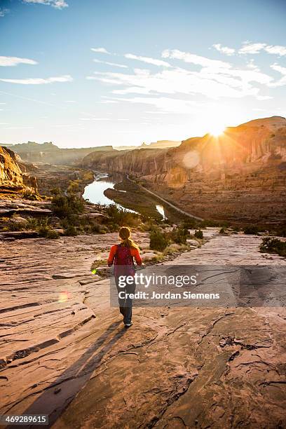female hiking trail at sunset - moab utah fotografías e imágenes de stock
