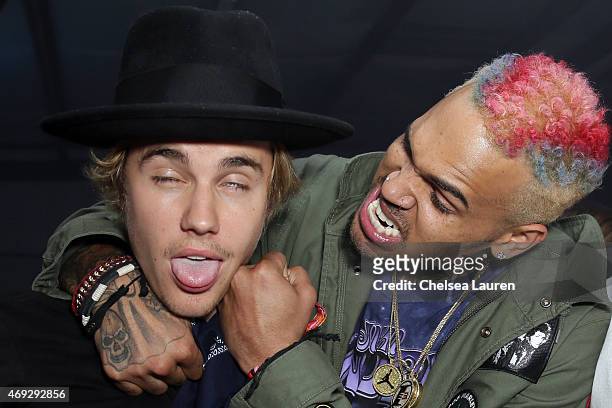 Singers Justin Bieber and Chris Brown attend the NYLON Midnight Garden Party at a private residence on April 10, 2015 in Bermuda Dunes, California.