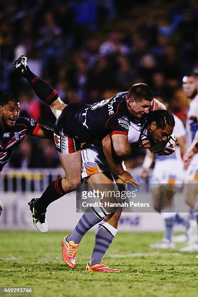 Jacob Lillyman of the Warriors tackles Martin Taupau of the Tigers during the round six NRL match between the New Zealand Warriors and the Wests...