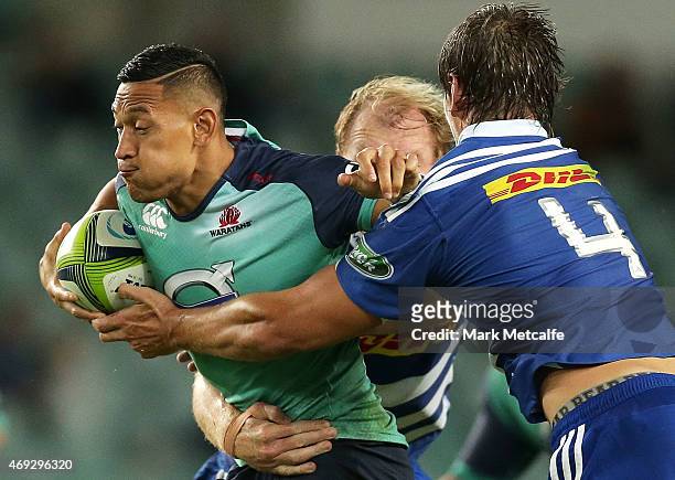 Israel Folau of the Waratahs is tackled by Schalk Burger and Eben Etzebeth of the Stormers during the round nine Super Rugby match between the...