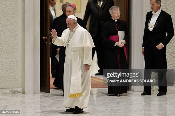 Pope Francis waves to members of the Istituti di Vita Consacrata and Società di Vita Apostolica , as he arrives, for his meeting in Aula Paolo VI at...