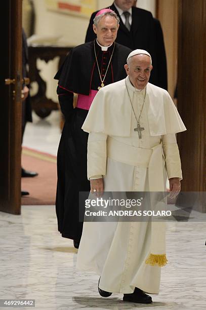 Pope Francis smiles towards members of the Istituti di Vita Consacrata and Società di Vita Apostolica , as he arrives, for his meeting in Aula Paolo...