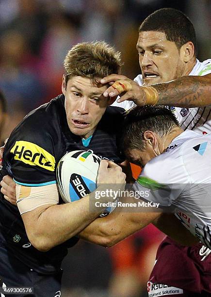 Jeremy Latimore of the Panthers is tackled by Willie Mason of the Sea Eagles during the round six NRL match between the Penrith Panthers and the...