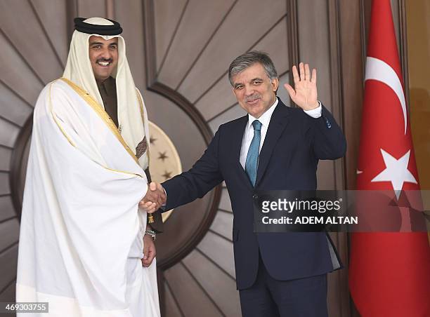 Turkish President Abdullah Gul welcomes Qatar's Emir Sheikh Tamim bin Hamad al-Thani before a meeting in Ankara, Turkey on February 14, 2014. AFP...
