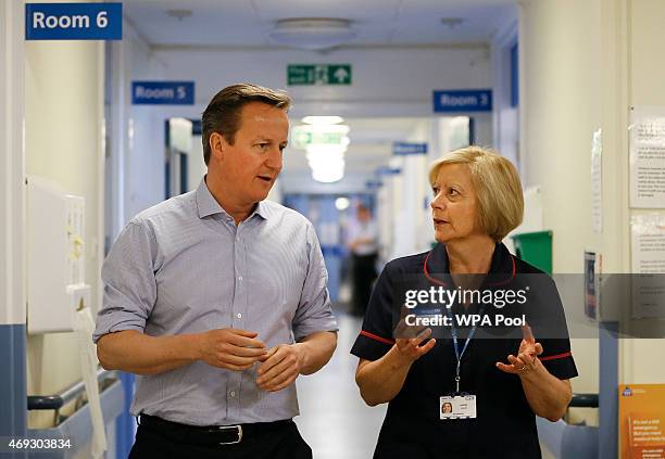 Britain's Prime Minister David Cameron speaks to matron Sandra Allen during a visit to Whitney Community Hospital on April 11, 2015 in Whitney,...