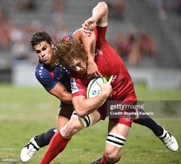 Eddie Quirk of the Reds is tackled during the Super Rugby trial match between the Queensland Reds and the Melbourne Rebels at Ballymore Stadium on...