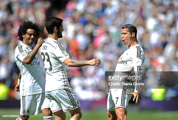 Cristiano Ronaldo of Real Madrid celebrates with Isco and Marcelo after scoring Real's opening goal from a free kick during the La Liga match between...