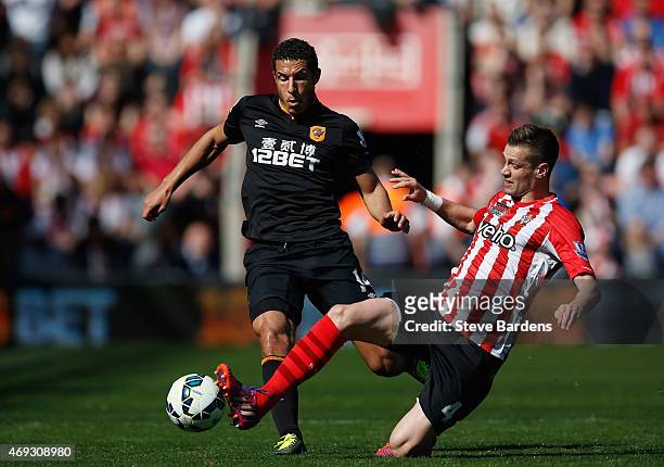 Jake Livermore of Hull City is tackled by Morgan Schneiderlin of Southampton during the Barclays Premier League match between Southampton and Hull...