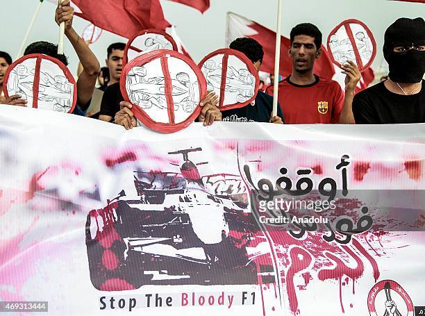 Group of protesters hold banners and placards demanding the cancellation of Formula 1 races which are planned to be held in Manama as they stage an...