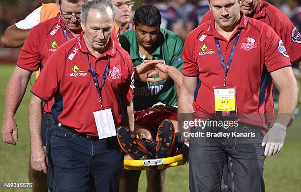 Quade Cooper of the Reds is taken from the field on a stretcher in a neck brace during the Super Rugby trial match between the Queensland Reds and...