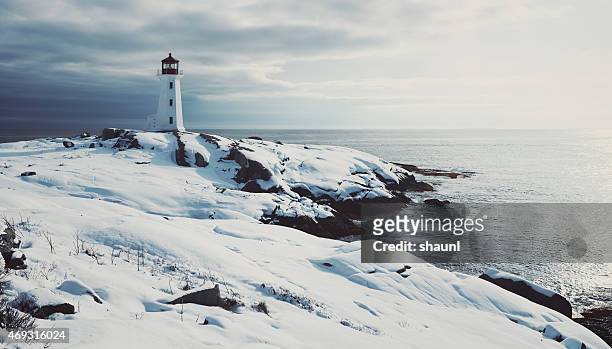 lighthouse in fresh snow - winter stock pictures, royalty-free photos & images
