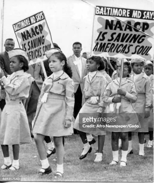Group of girl scouts marching, holding placards 'Baltimore MD says NAACP is saving America's soul', Baltimore, Maryland, 1950.