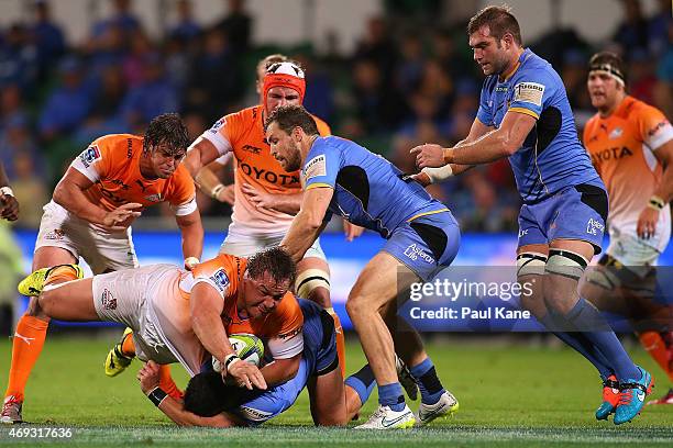 Coenie Oosthuizen of the Cheetahs gets tackled by Kane Koteka of the Force during the round nine Super Rugby match between the Force and the Cheetahs...