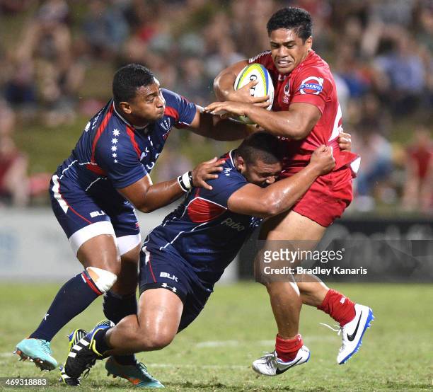 Ben Tapuai of the Reds is tackled during the Super Rugby trial match between the Queensland Reds and the Melbourne Rebels at Ballymore Stadium on...