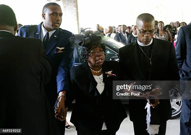 Judy Scott, center, is escorted in for the funeral of her son, Walter Scott, at W.O.R.D. Ministries Christian Center, April 11, 2015 in Summerville,...