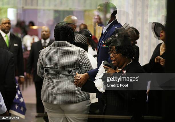 Judy Scott weeps as she is escorted in for the funeral of her son, Walter Scott, at W.O.R.D. Ministries Christian Center, April 11, 2015 in...