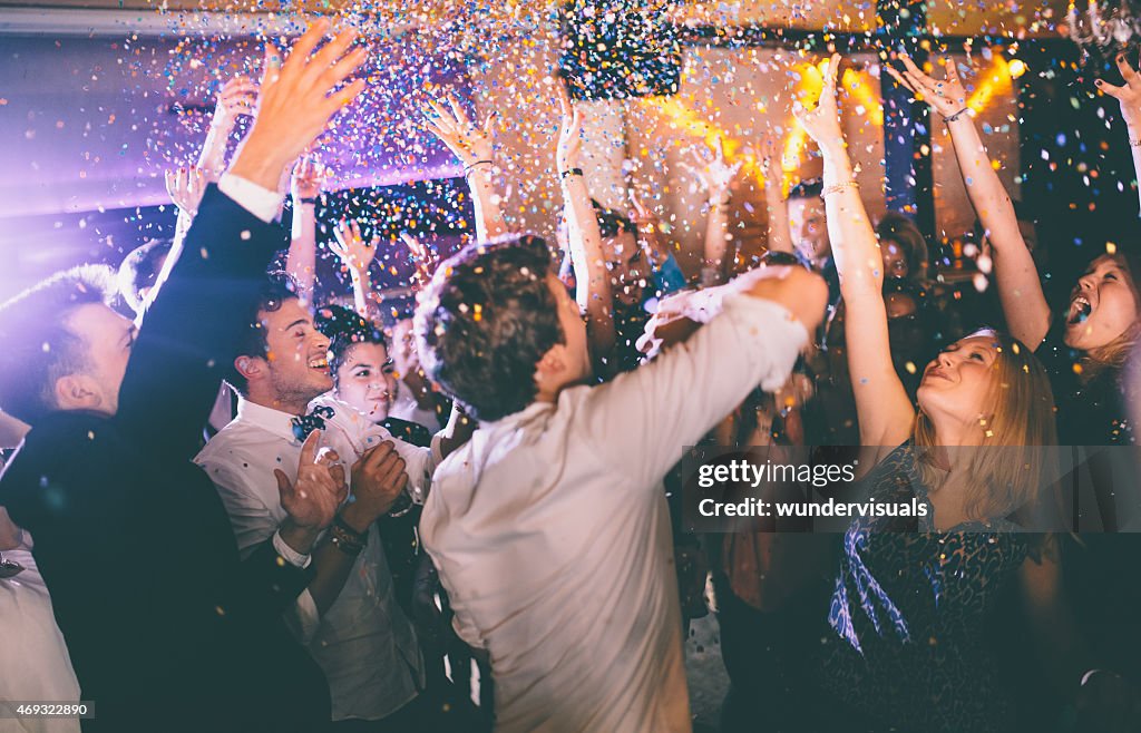 Group of hipsters throwing confetti at a party in celebrations