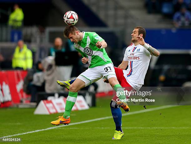 Pierre Michel Lasogga of Hamburg and Robin Knoche of Wolfsburg battle for the ball during the Bundesliga match between Hamburger SV and VfL Wolfsburg...