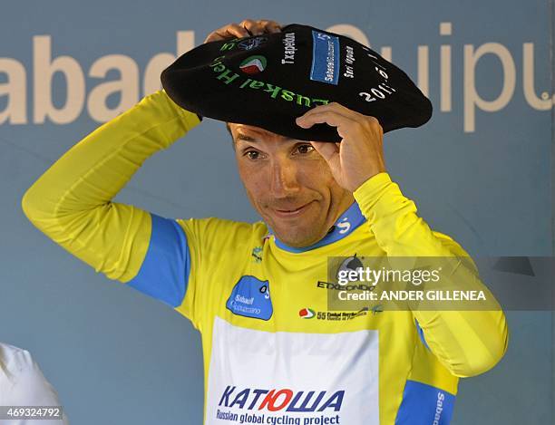 Katusha's Spanish rider Joaquim Rodriguez adjusts a Basque beret as he celebrates his victory on the podium of the last stage of the Tour of the...