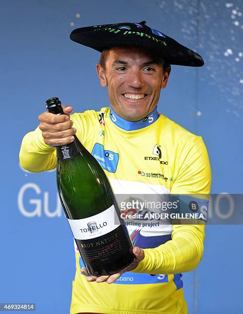 Katusha's Spanish rider Joaquim Rodriguez celebrates his victory with Cava on the podium of the last stage of the Tour of the Basque Country in Aia,...