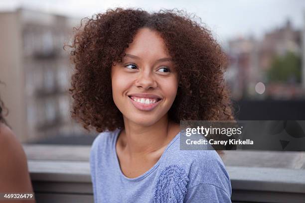 mixed race young woman at a roof party - 16 17 anos - fotografias e filmes do acervo