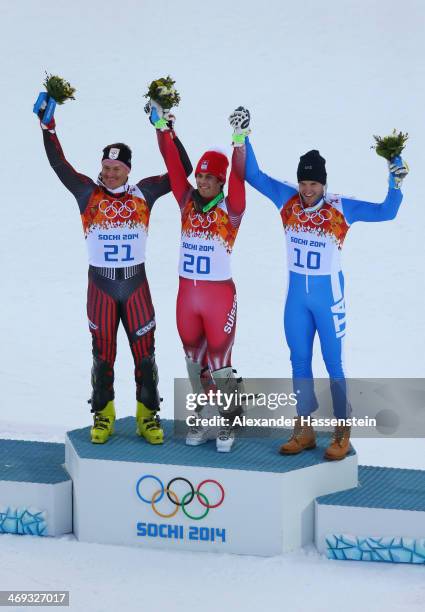 Silver medalist Ivica Kostelic of Croatia, gold medalist Sandro Viletta of Switzerland and bronze medalist Christof Innerhofer of Italy celebrate...
