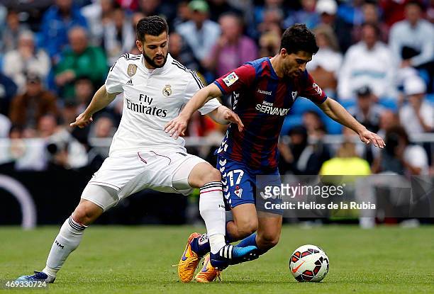 Nacho Fernandez of Real Madrid and Didac Vila of Eibar compete for the ball during the La Liga match between Real Madrid CF and Eibar at Estadio...