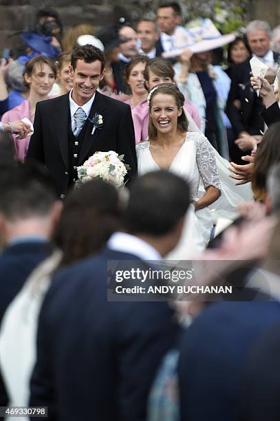 British tennis player Andy Murray and his new wife Kim Sears smile as they are showered in confetti after being married at Dunblane Cathedral on...