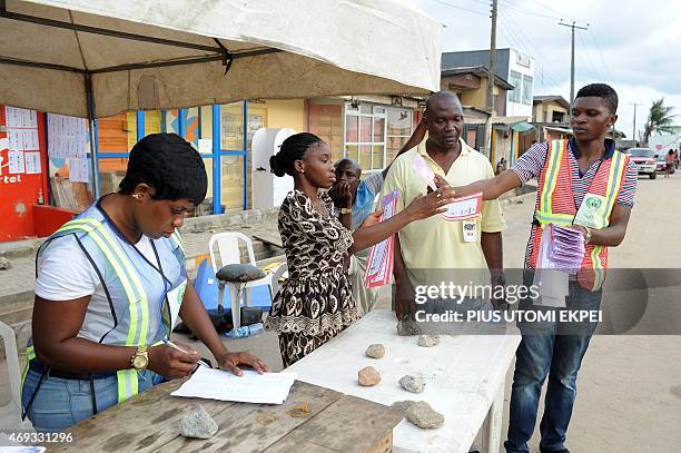 Officials of Independent National Electoral Commission count ballots after gubernatorial and local assembly elections in Lagos on April 11, 2015....