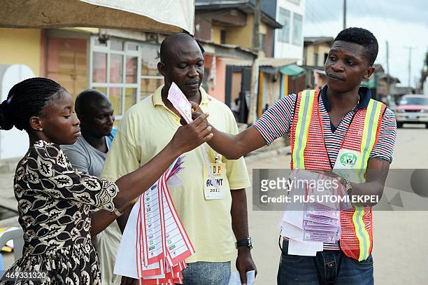 Officials of Independent National Electoral Commission count ballots after gubernatorial and local assembly elections in Lagos on April 11, 2015....