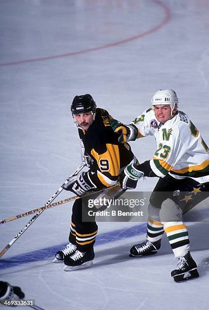 Brian Bellows of the Minnesota North Stars tries to hook Bryan Trottier of the Pittsburgh Penguins during Game 3 of the 1991 Stanley Cup Finals on...