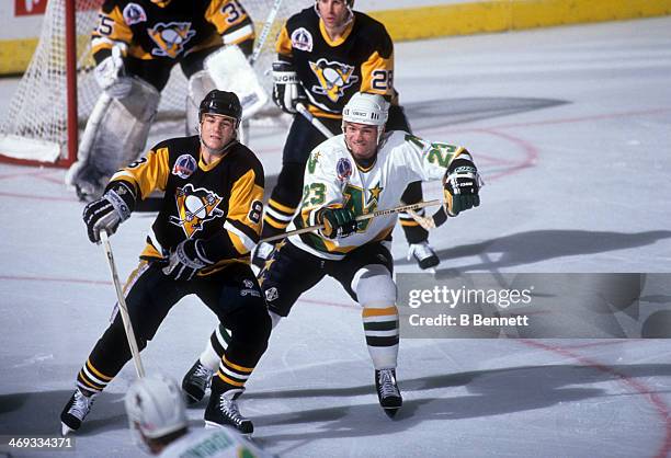 Brian Bellows of the Minnesota North Stars hooks Mark Recchi of the Pittsburgh Penguins during the 1991 Stanley Cup Finals in May, 1991 at the Met...