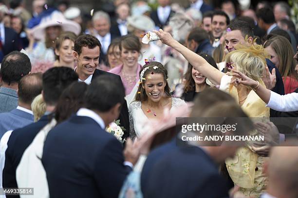 British tennis player Andy Murray and his new wife Kim Sears smile as they are showered in confetti on their wedding day at Dunblane Cathedral on...