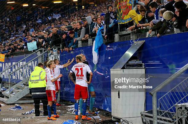 Supporters of Hamburg argue with Rene Adler, Heiko Westermann and Valon Behrami of Hamburg after the Bundesliga match between Hamburger SV and VfL...
