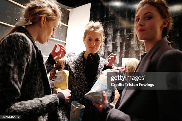 Models are seen backstage prior to the Haizhen Wang presentation at London Fashion Week AW14 at Somerset House on February 14, 2014 in London,...