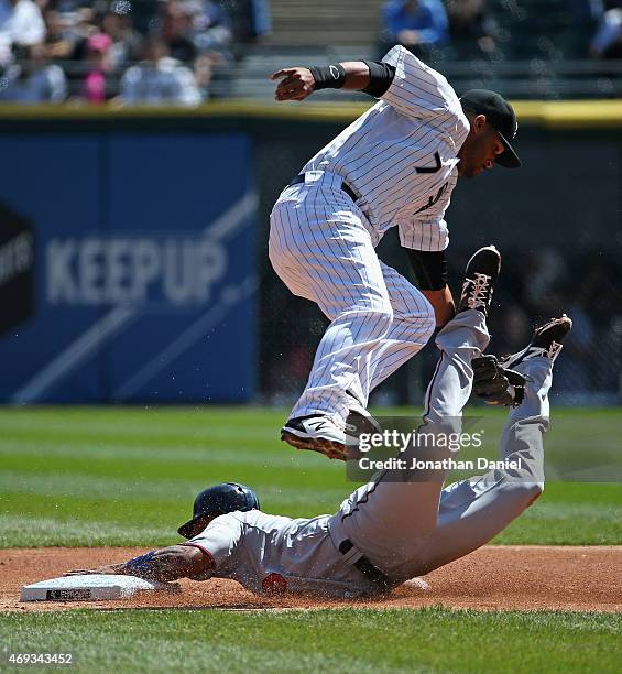 Danny Santana of the Minnesota Twins steals second base as Micah Johnson of the Chicago White Sox leaps to try and make the tag in the 1st inning at...