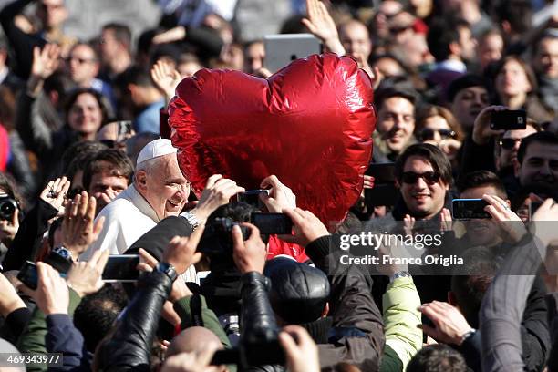 Pope Francis greets engaged couples from all over the world gathered today, on the feast of St. Valentine, in St. Peter's Square February 14, 2014 in...