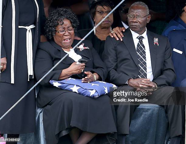 Judy Scott is overcome with emotion as she sits with her husband Walter Scott Sr. During the burial service for their son, Walter Scott, at the Live...