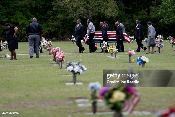 The flag drapped coffin of Walter Scott is carried by pallbearers to his burial site at the Live Oak Memorial gardens cemetery, after he was fatally...