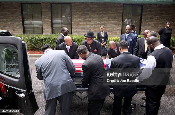 Pallbearers carry the casket of Walter Scott to the hearse after a funeral service at the W.O.R.D. Ministries Christian Center, after he was fatally...