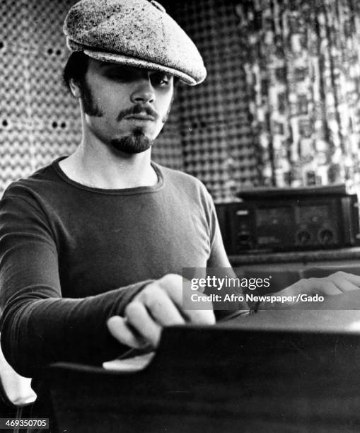 Portrait of the songwriter and musician Peter Brown, seated at a piano or mixing desk in a recording studio, January 13, 1979.