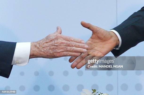 President Barack Obama shakes hands with Cuba's President Raul Castro on the sidelines of the Summit of the Americas at the ATLAPA Convention center...