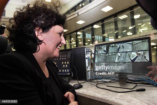 Minister of Justice Annemie Turtelboom looks at a computer in a control room during the official opening of a new jail in Melsele, Beveren, one of...