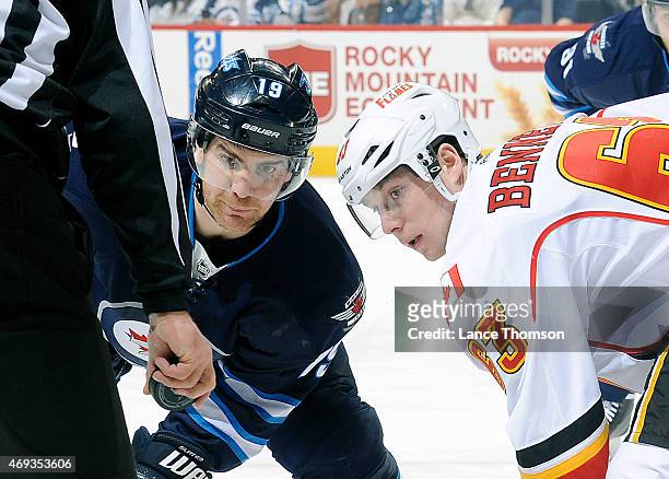 Jim Slater of the Winnipeg Jets and Sam Bennett of the Calgary Flames get set for a first period face-off on April 11, 2015 at the MTS Centre in...