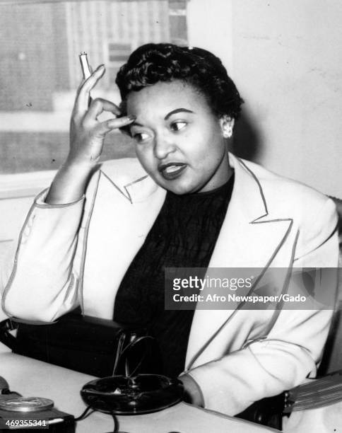 Portrait of Mamie Till Bradley, mother of Emmett Till, the teenager murdered in a racially motivated attack in Mississippi, smoking a cigarette,...