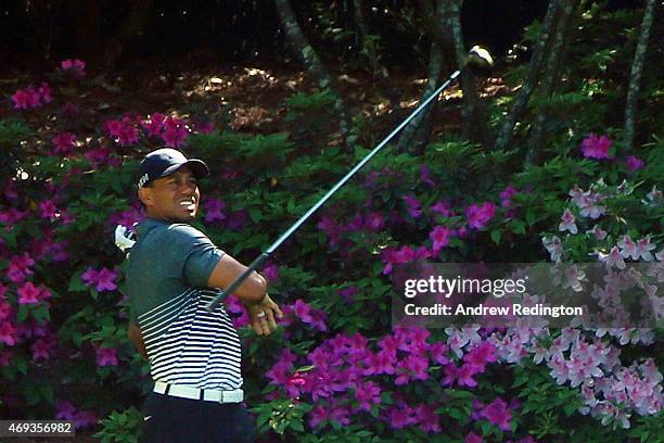 Tiger Woods of the United States loses his driver after a poor tee shot on the 13th hole during the third round of the 2015 Masters Tournament at...