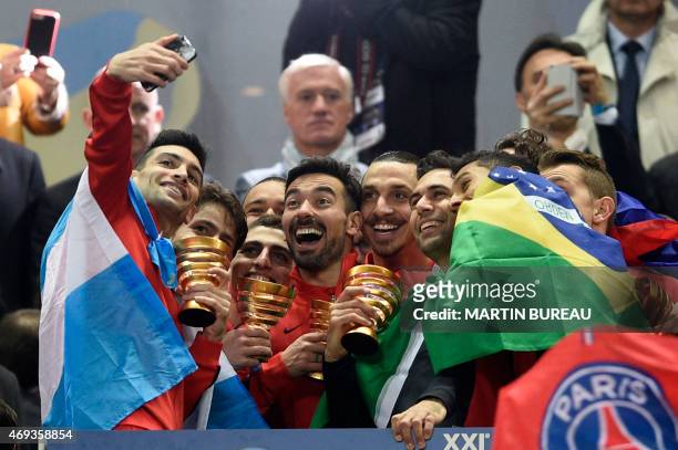Paris Saint-Germain's Argentinian midfielder Javier Pastore takes a selfie as Paris' players celebrate their victory at the end of the French League...