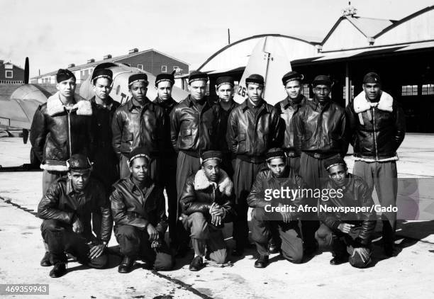 Photograph of Tuskegee Airmen during World War II, wearing leather bomber jackets and standing with an airplane, Tuskegee, Alabama, 1944.