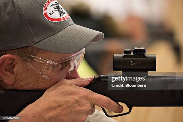 National Rifle Association logo appears on the hat of a shooting instructor at an air gun range during the 144th NRA Annual Meetings and Exhibits at...